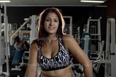 attractive fitness model relaxes on exercise bike, melbourne