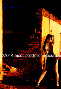 model poses for portfolio image near outback ruin